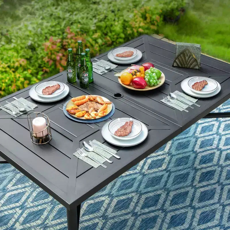 Set da pranzo per esterni 7 pezzi: tavolo in acciaio, sedie in vimini, cuscini - Captiva Designs