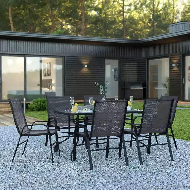 Set da patio sette pezzi Emma and Oliver con tavolo in metallo con piano in vetro temperato e 6 sedie impilabili Flex Comfort